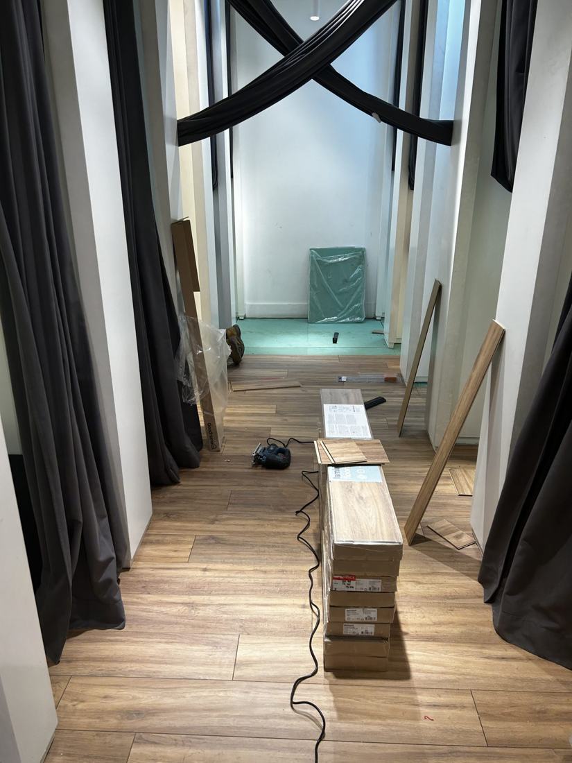 Laminate flooring being installed along a corridor