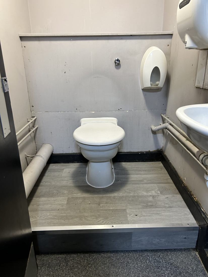Accessible WC with new raised flooring in a commercial unit