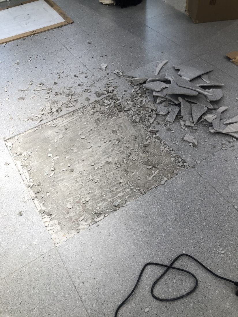 Old floor tiles being removed from a commercial floor