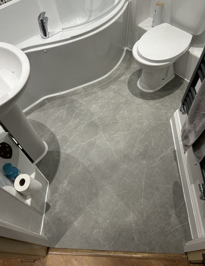 Bathroom with new grey stone-effect vinyl flooring