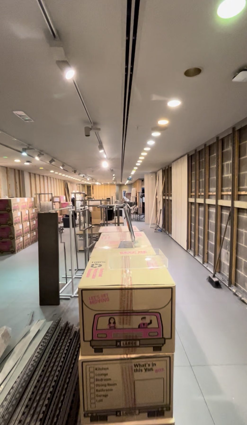 Shop unit during closure, with stock being cleared and walls stripped back